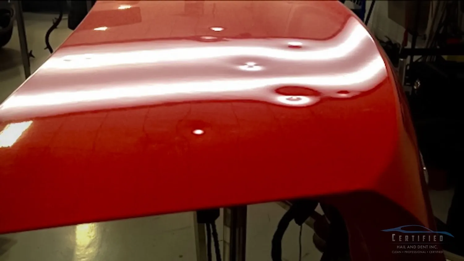 Hail damage on a hood before repair in Colorado Springs