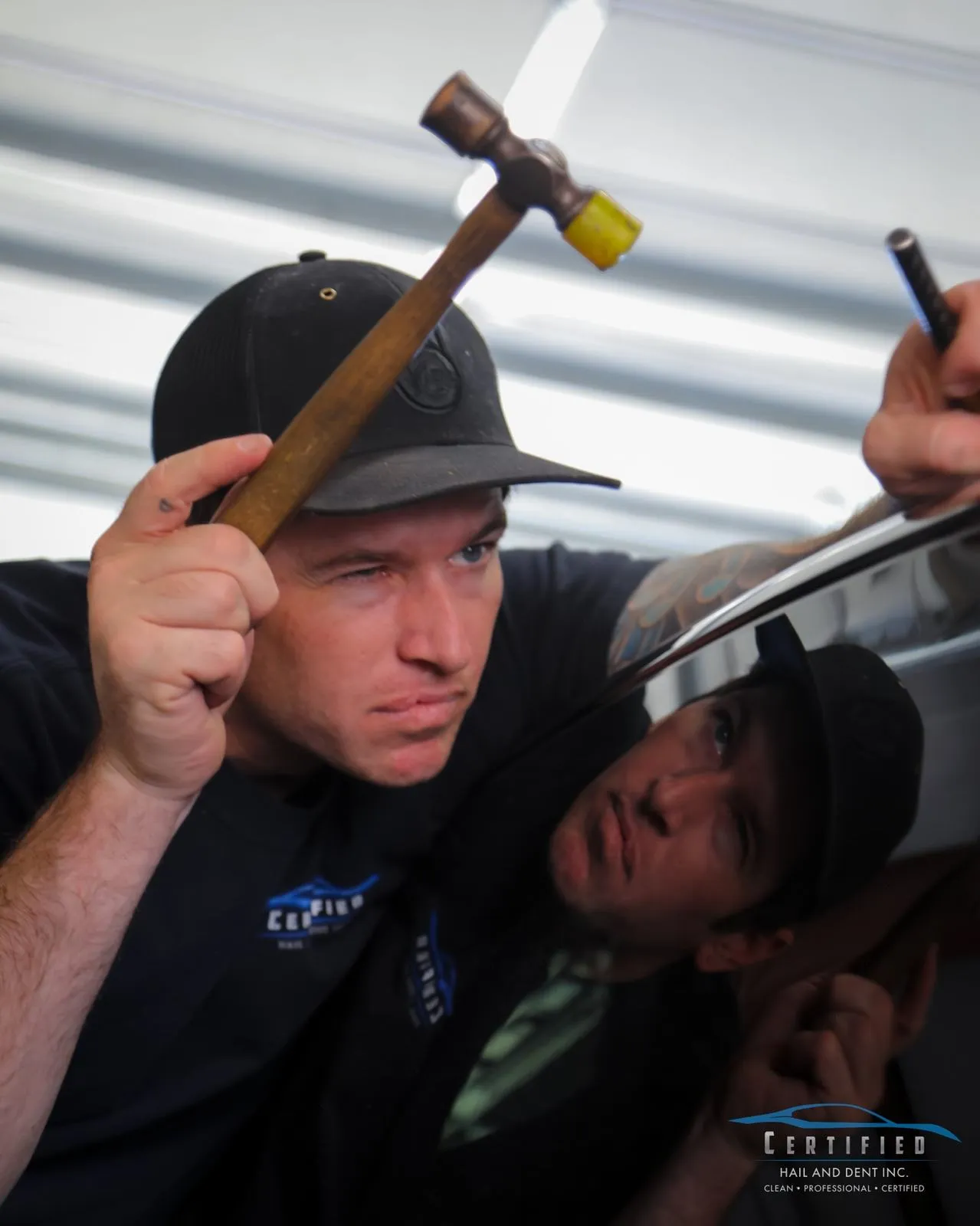Technician using a knockdown hammer on a hail dent Colorado Springs